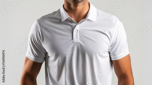 A man in a white polo shirt and white pants is posing for a photo