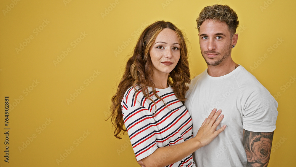 A loving couple embracing against a vibrant yellow background, displaying affection and happiness in their relationship. A loving couple embracing against a vibrant yellow background, displaying affection and happiness in their relationship.