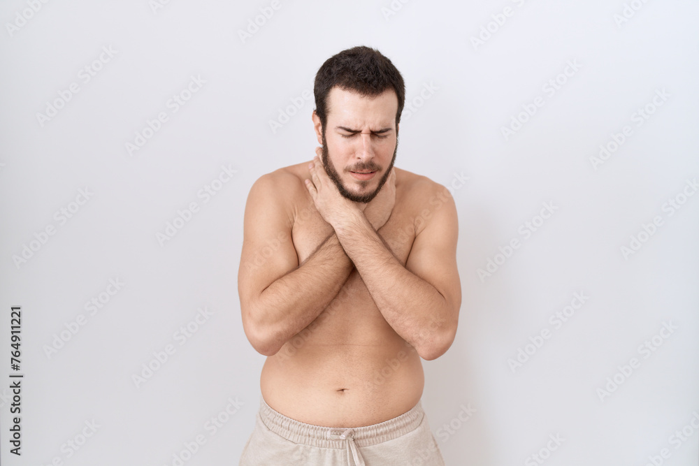 Young hispanic man standing shirtless over white background shouting and suffocate because painful strangle. health problem. asphyxiate and suicide concept. Young hispanic man standing shirtless over white background shouting and suffocate because painful strangle. health problem. asphyxiate and suicide concept.
