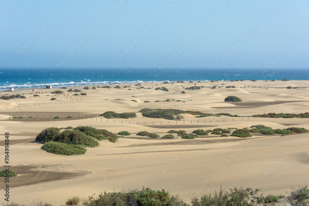 Sandy beach of Maspalomas with a view of the sea on Gran Canaria in Spain Sandy beach of Maspalomas with a view of the sea on Gran Canaria in Spain
