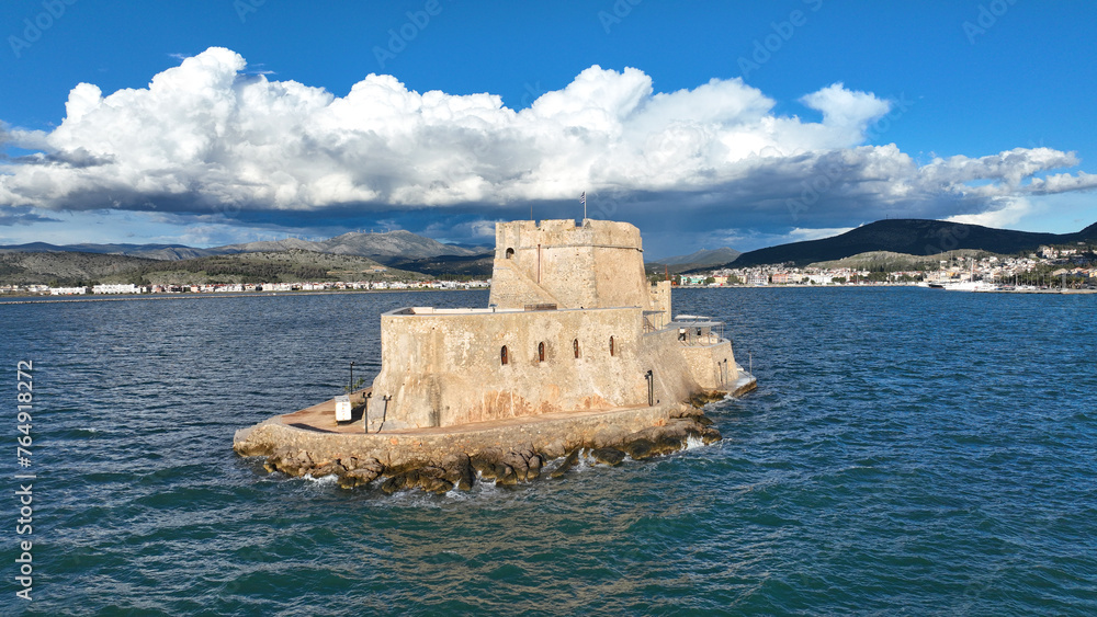 Aerial drone photo of castle of Bourtzi built at sea a popular attraction in city of Nafplio former capital of Greece as seen in the morning with nice white clouds and deep blue sky, Argolida, Greece