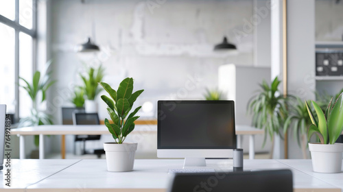Modern office space interior with green plants, desks and computers, empty room with white design. Theme of business, table, commercial building. © Natalya