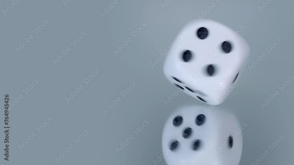 The dice spins on a mirror surface, describing circles. Will fate bring you luck in gambling. Closeup. Macro. Slow mo, slo mo, slow motion, high speed camera, 240fps, 250fps The dice spins on a mirror surface, describing circles. Will fate bring you luck in gambling. Closeup. Macro. Slow mo, slo mo, slow motion, high speed camera, 240fps, 250fps