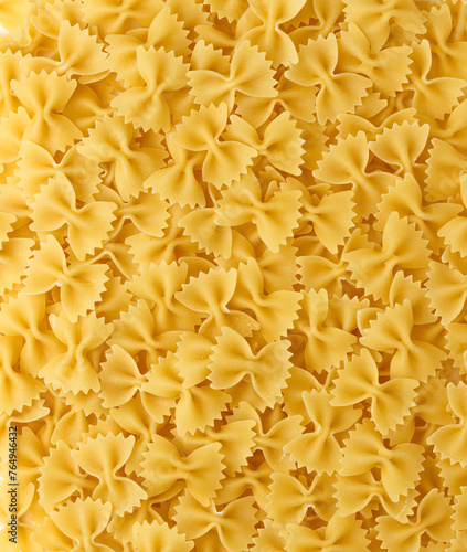 Italian Pasta Farfalle Background. Uncooked Bow Tie Pasta Close-up. Food Creative Concept. Top view, directly above.