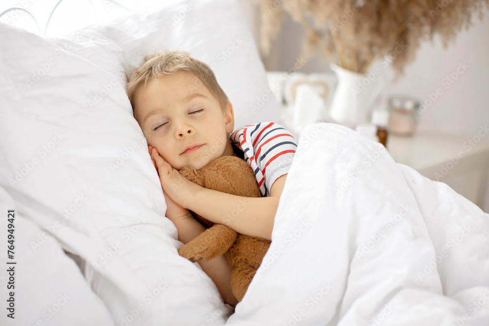 Sweet blond preschool child with teddy bear, lying in bed sick, Sweet blond preschool child with teddy bear, lying in bed sick,