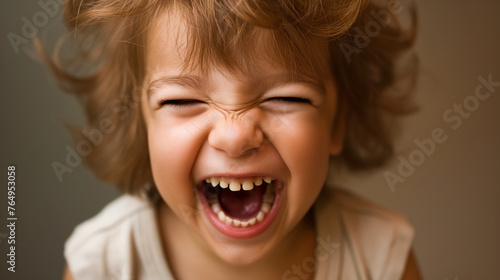 Laughing child with a big, joyful smile.