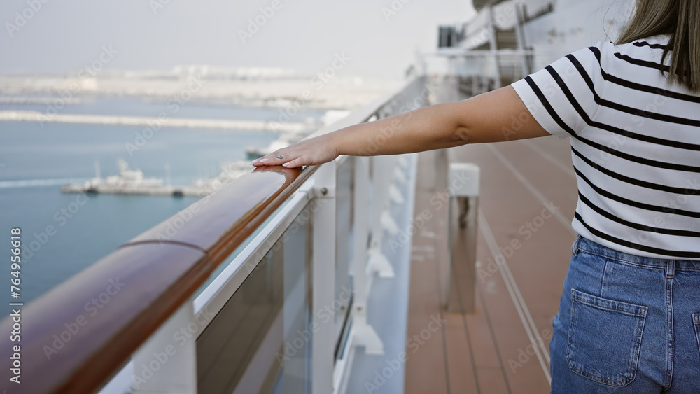 Young woman enjoying a serene sea view from the deck of a cruise ship, embodying leisure and travel. Young woman enjoying a serene sea view from the deck of a cruise ship, embodying leisure and travel.