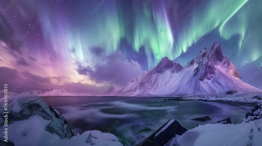 Beautiful aurora northern lights in night sky with snow mountain forest in winter.