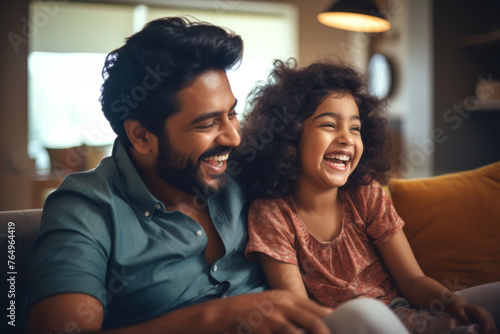 Loving young father of Indian ethnicity and little daughter having a fun time at home