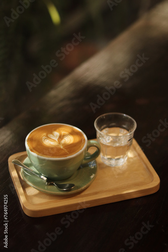 A cup latte art on the wood table