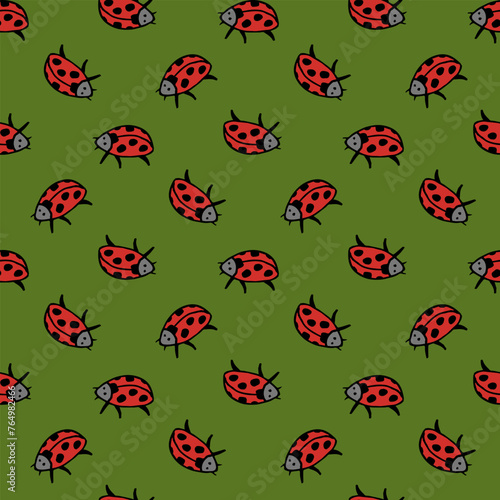 Seamless pattern in wondrous ladybug on green background. Vector image.