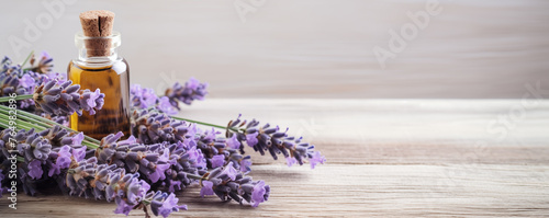 fresh lavender with Bottles of essential oil on a light wooden background, banner with copy space for text