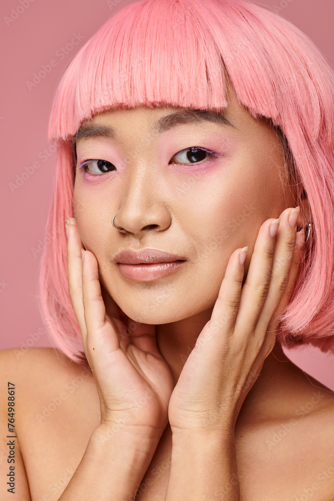 portrait of charming asian girl with nose piercing touching cheek with hands on vibrant background portrait of charming asian girl with nose piercing touching cheek with hands on vibrant background