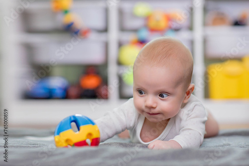 Baby reaching for toy. Baby development