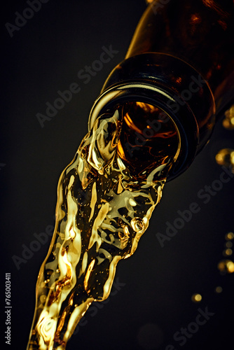 Close-up of beer bottle with chill lager beer pouring against dark background. Golden drink with bubbles. Concept of alcohol and non-alcohol drinks, refreshment. Poster, banner for ad
