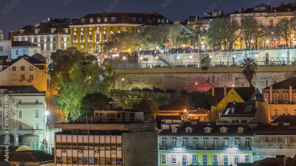 Aerial view over the center of Lisbon to the viewpoint called Miradouro de Sao Pedro de Alcantara night timelapse.