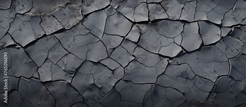 Close-up view of cracked wallpaper in shades of black and grey against a dark background photo