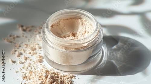 Loose powder in a transparent jar, commonly used in cosmetics promotional photo