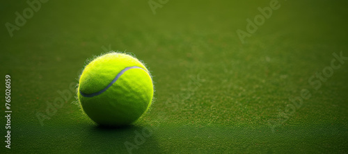 Tennis ball with felt exterior lies on court grass surface closeup. Classic fluorescent yellow ball for tennis awaits upcoming game session