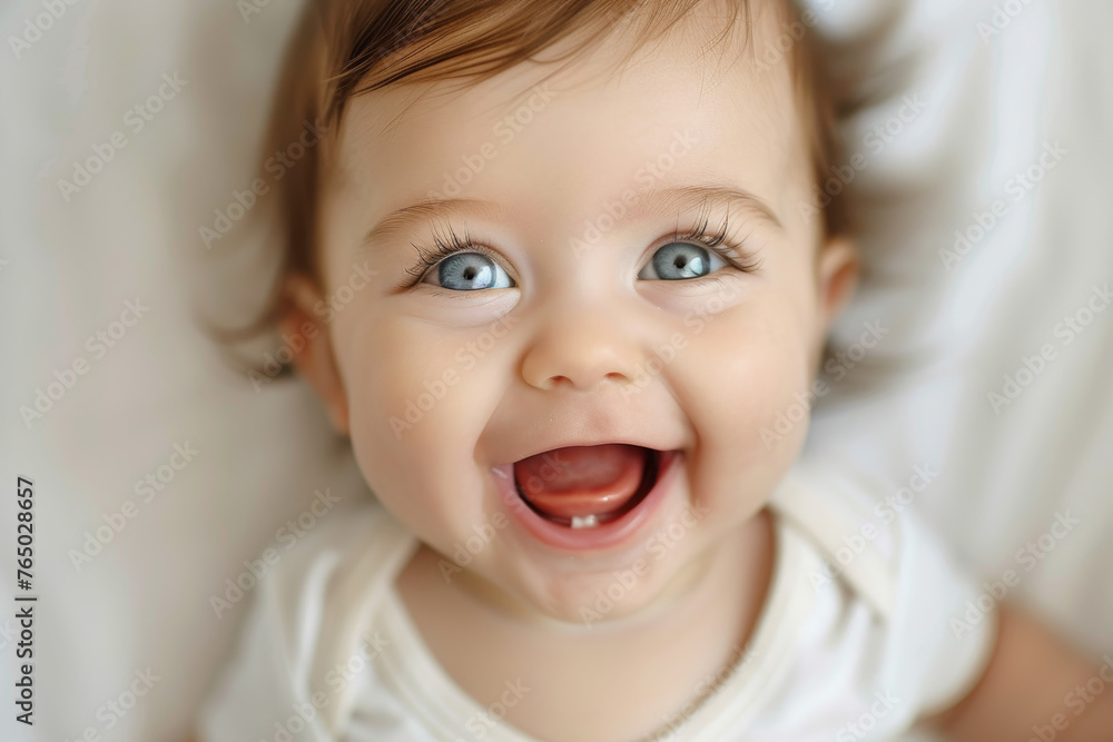A baby is smiling and has blue eyes