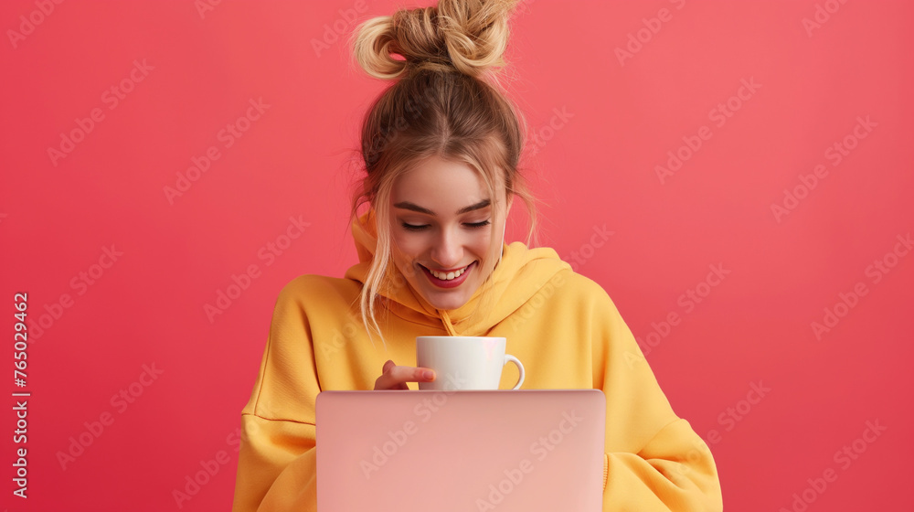 Happy young woman eating cereals and using laptop on Coral color background professional photography. Happy young woman eating cereals and using laptop on Coral color background professional photography.