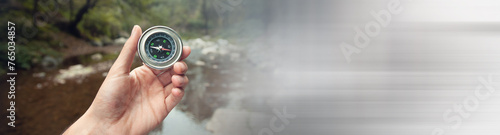 man hand compass in forest background