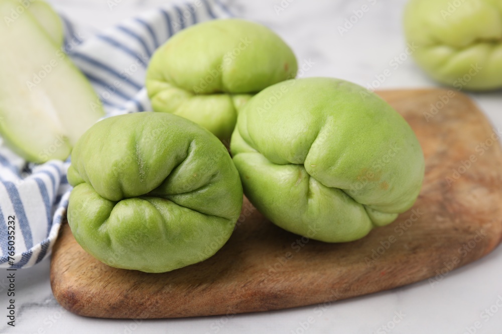 Fresh green chayote on light table, closeup Fresh green chayote on light table, closeup