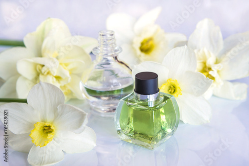 Spring holidays concept  fragrance and essential oil concept  vial with essential oil from narcissus flowers on white background