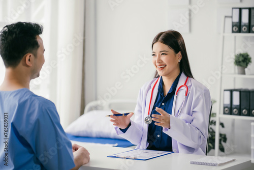 A woman doctor is talking to a man in a hospital room