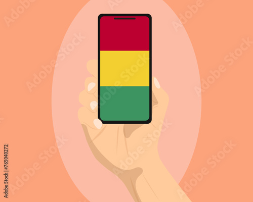 Guinea flag on mobile phone screen, holding smartphone, advertising social media or banner concept