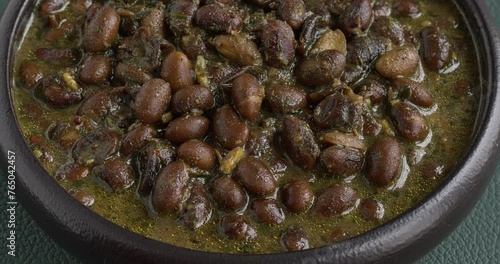 Black soybeans cooked in spices. Bhat ki Chudkani - a traditional dish of the Kumaon region. Table spin.  photo