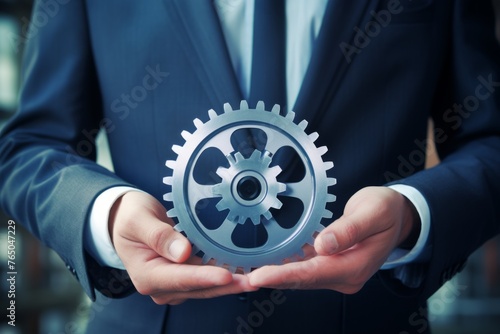 Man holding gear in hands. Teamwork metallic silver equipment industrial progress engineering machine mechanical cog wheel technology steel power transmission motion circle construction development