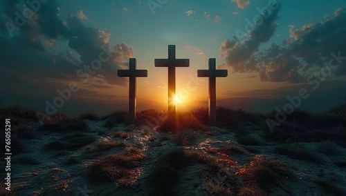 Three wooden crosses on a hill at sunset