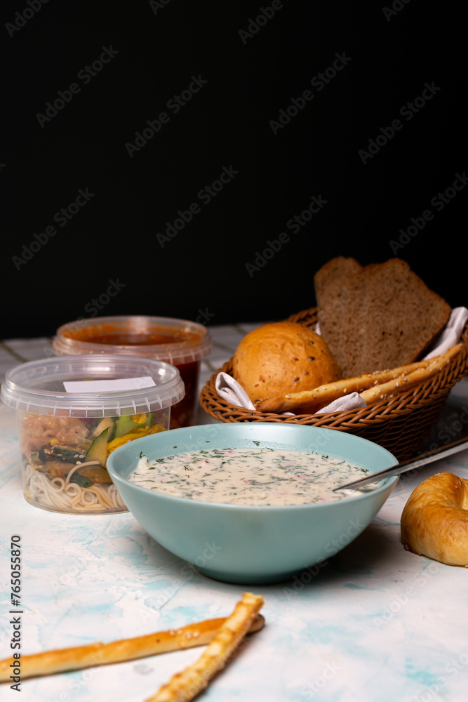 a plate of okroshka and fresh bread on the table