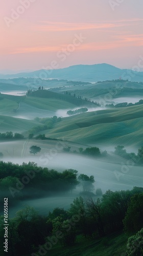 Misty hills at sunrise capture the ethereal beauty and soft light. © SHI