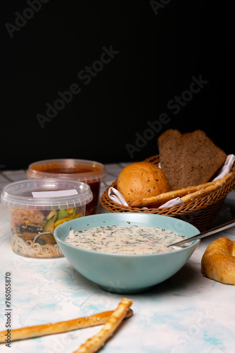 Fototapeta Naklejka Na Ścianę i Meble -  a plate of okroshka and fresh bread on the table