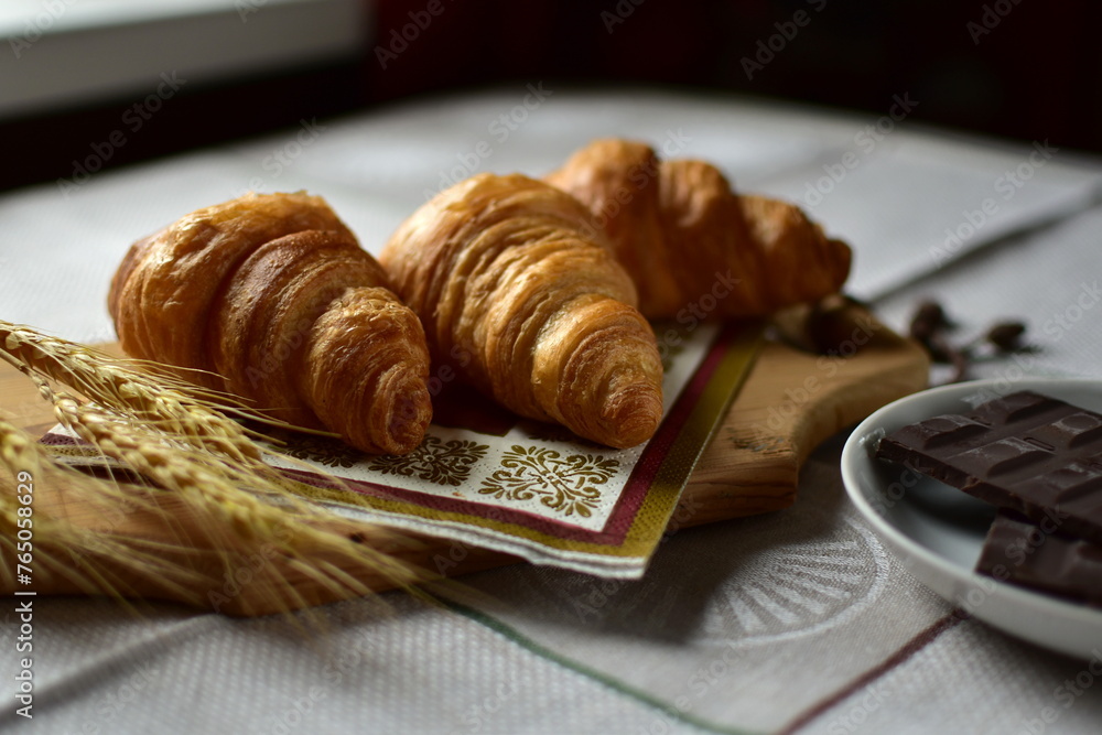 croissants with chocolate on a wooden board