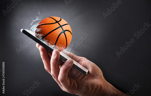 Konstfotografi Concept watching basketball online with hand with mobile and ball