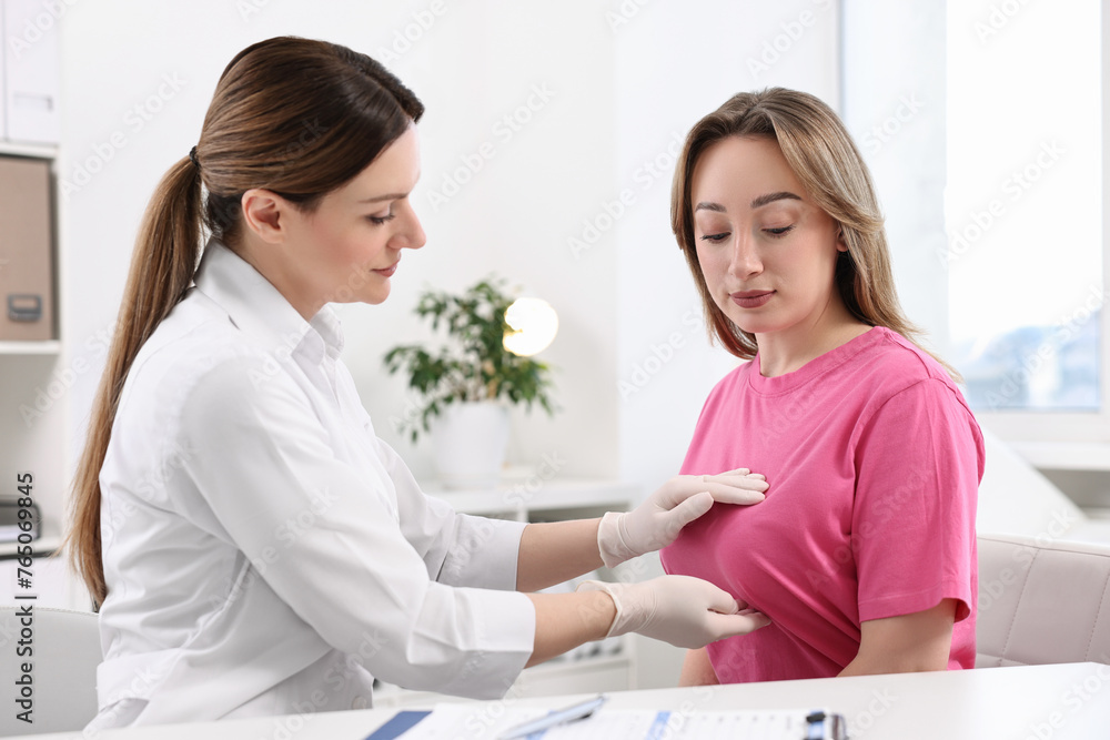 Mammologist checking young woman's breast in hospital Mammologist checking young woman's breast in hospital