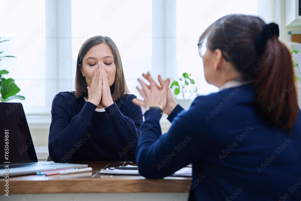Sad, upset young woman patient at mental therapy session with psychologist Sad, upset young woman patient at mental therapy session with psychologist