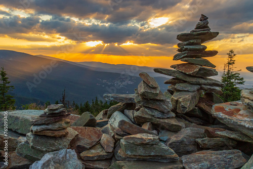 Fototapeta Naklejka Na Ścianę i Meble -  Stone cairns at sunset (Skalny Stół) in summer with a view of Śnieżka and the entire Karkonosze