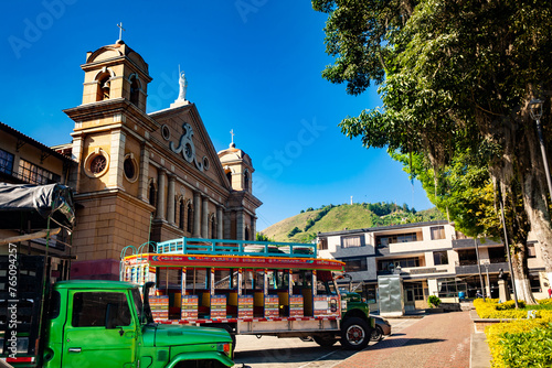 Colorful traditional rural bus from Colombia called chiva at the central square of the small town of Pacora in Colombia photo