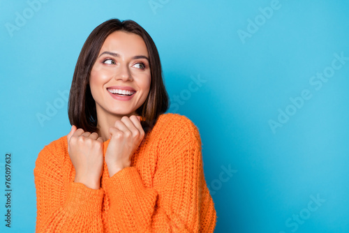 Portrait of attractive cheerful girl wearing soft wool clothes thinking copy space isolated over bright blue color background © deagreez