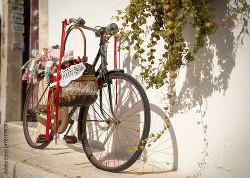 Antique bicycle with basket.. Somewhere on an Italian avenue. © Marcin