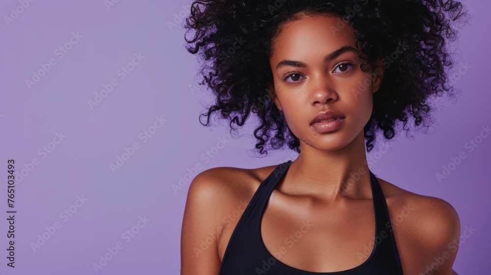 Attractive fit black female model wearing sporty outfit on pastel purple background. Banner for fitness, lifestyle, sports.