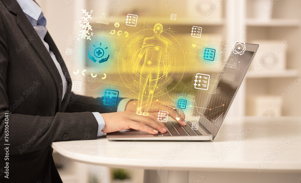 Doctor working on laptop with healthcare concept Doctor working on laptop with healthcare concept