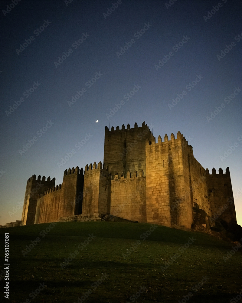 Guimarães Castle under the crescent moon at night, Guimarães, Braga, Portugal, December 2017