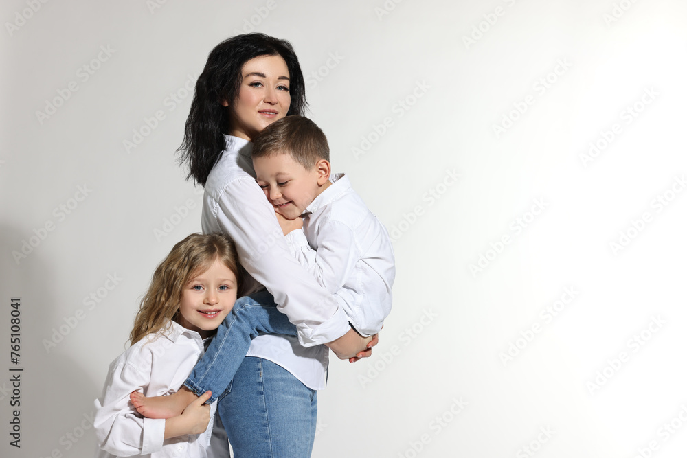 Little children with their mother on white background. Space for text Little children with their mother on white background. Space for text