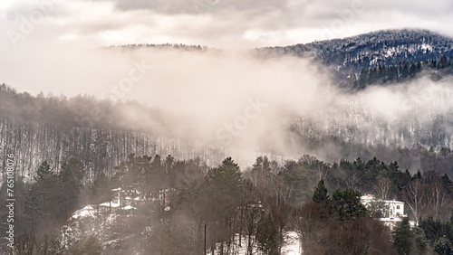 Aerial view of the mountains in the fog in the Poprad Landscape Park on a winter morning.