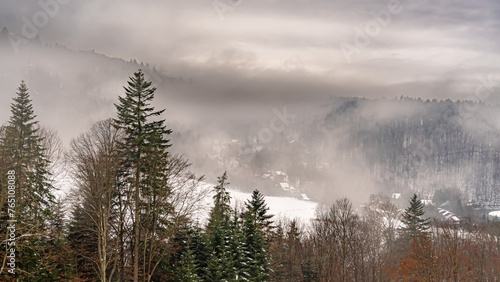 Aerial view of the mountains in the fog in the Poprad Landscape Park on a winter morning.
